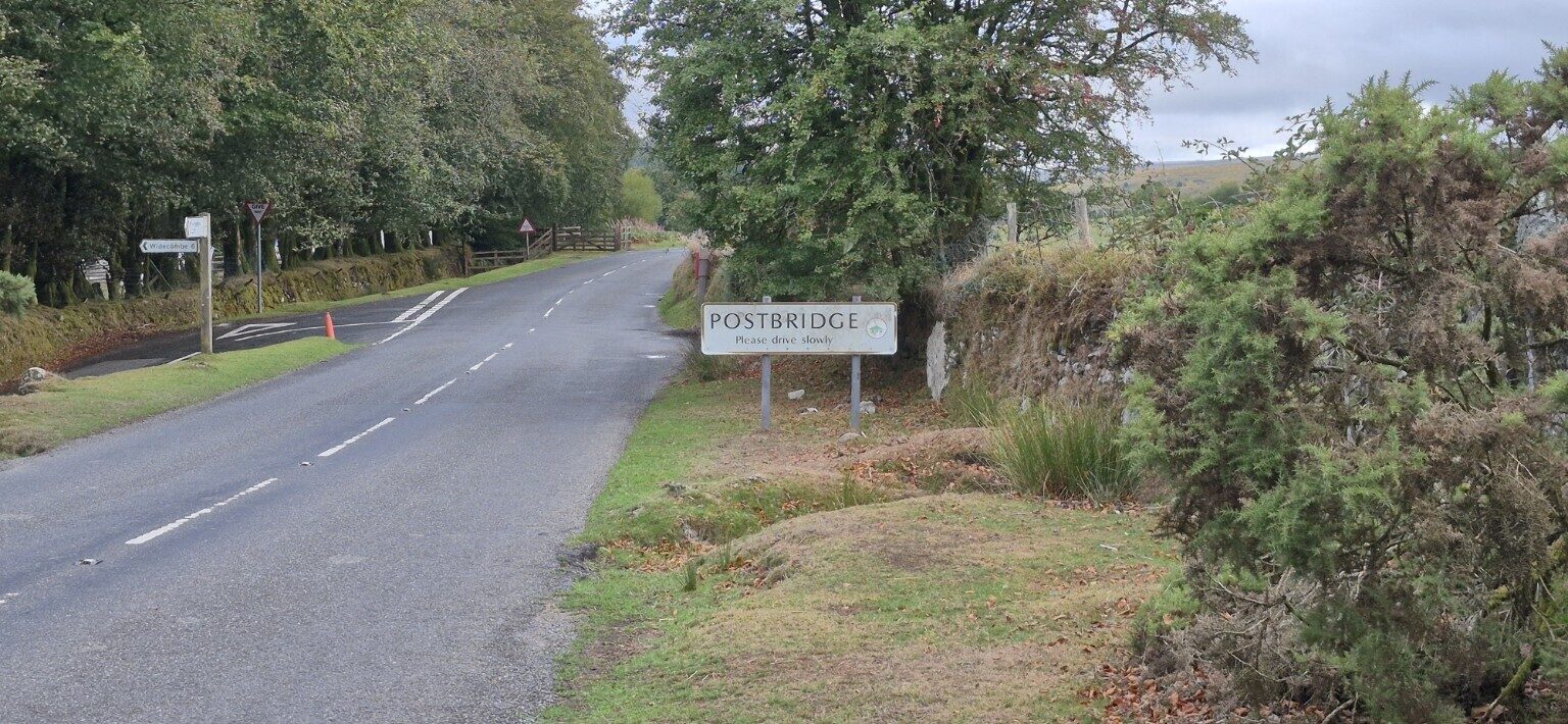 Postbridge village sign beside the road