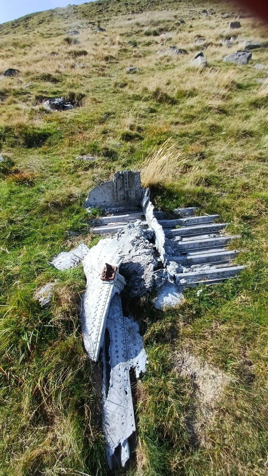 Aircraft wreckage lying in the grass near Kitty Tor